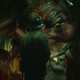 Stan Carlisle faces away from the camera, toward the mouth of a devilish carnival door.